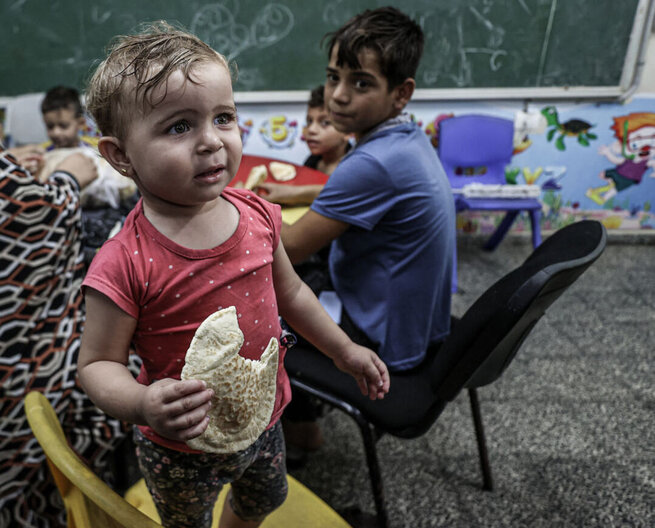 WFP bread distribution at UNRWA school that is a designated shelter in times of emergency.