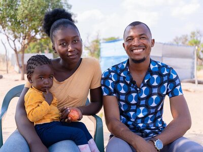 A man, his wife, and their child.