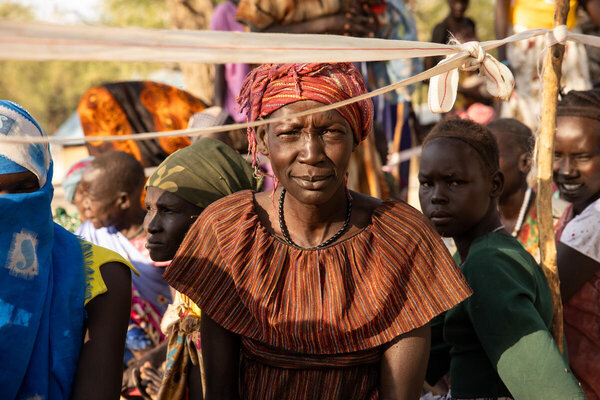A woman waiting at a distribution in South Sudan, Pieri in Jonglei State, where a community cut off by conflict and flooding received airdrops in February. Photo: WFP/Samantha Reinders