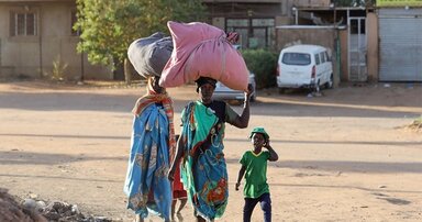 People flee their neighbourhoods amid fighting between the army and paramilitaries in Khartoum on April 19, 2023, following the collapse of a 24-hour truce. 