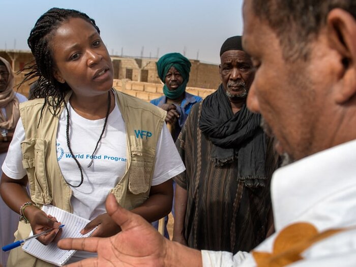 WFP staff talking to a group of men