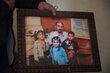 Abo Hashim hold a photo of his family and children before the conflict