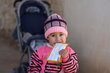 A two-year old Syrian girl eating a sachet of supplementary feeding butter.
