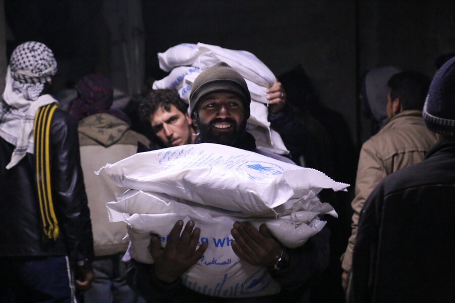 A man carrying WFP monthly ration in Madaya town on the first crossline mission in January 2016. 