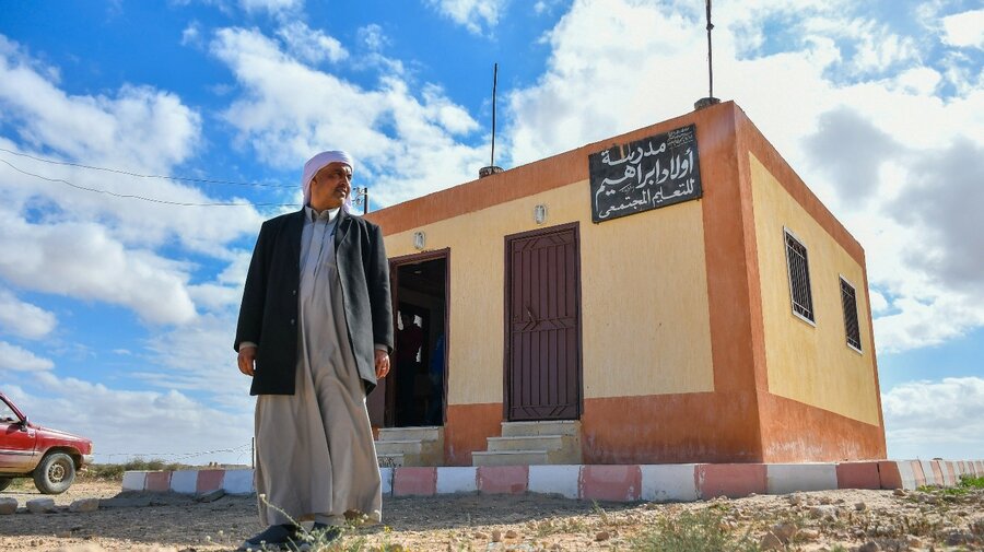Mahmoud Ibrahim stands in front of the school he built himself and now bears his family name 