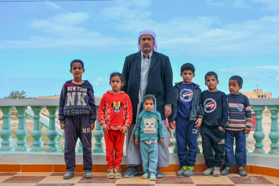Mahmoud surrounded by six of his children, two girls and four boys.