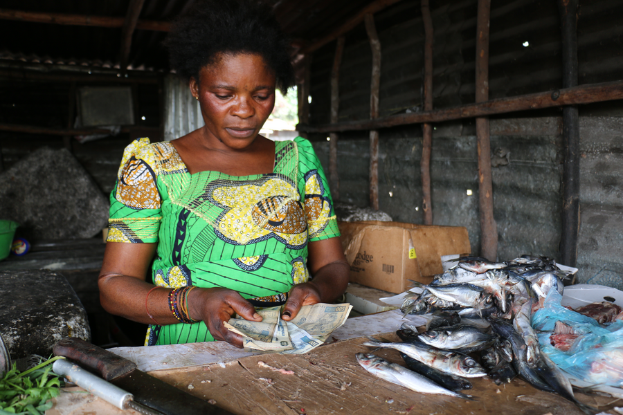 a woman is counting money on the desk she is working