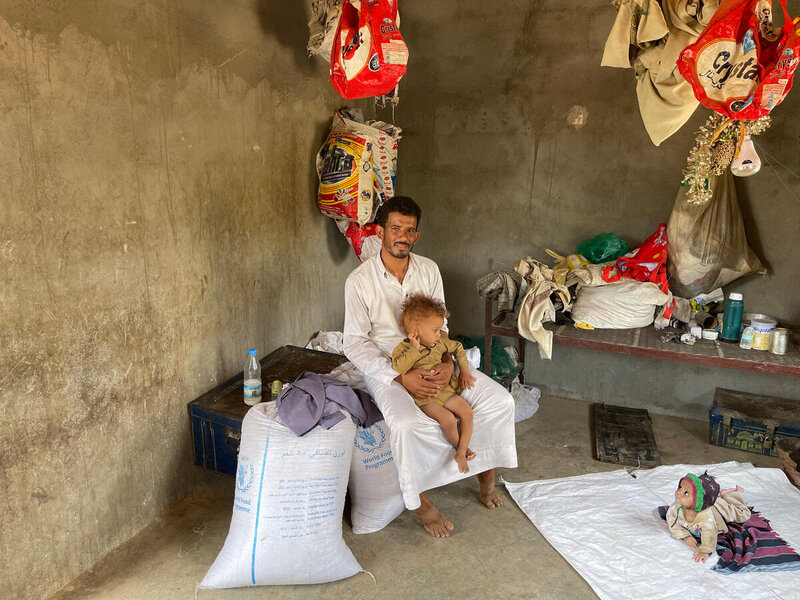 Abdullatif, 35, with his children at their very simple house