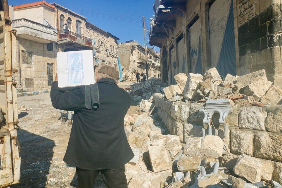 A man carries home WFP food in northwest Syria, where the earthquakes complicate an acute humanitarian crisis. Photo: WFP/Lina Alqassab