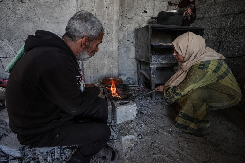 Palestine. Family cooking on the rubble of their home