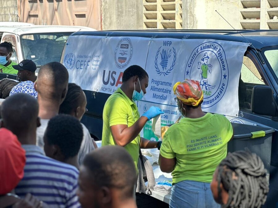 people queueing at food distribution in Haiti