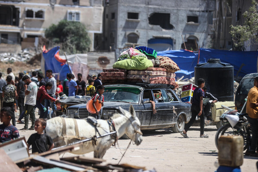 A old Mercedes packed with mattresses makes off from Rafah