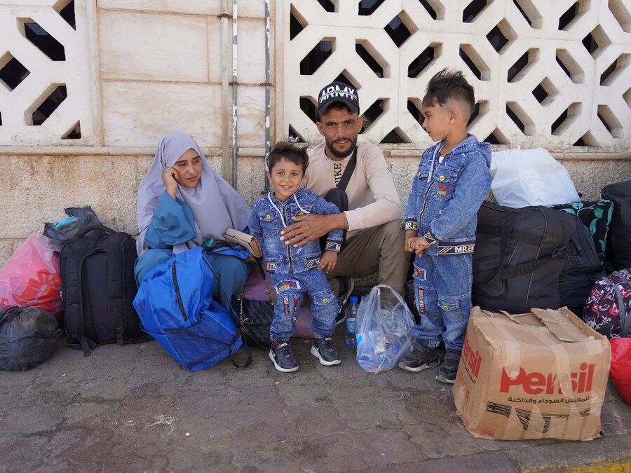 Bushra (L) and her family at a Syrian border crossing. They have no idea where they'll shelter in Syria. Photo: WFP/Ghazwan Jabasini