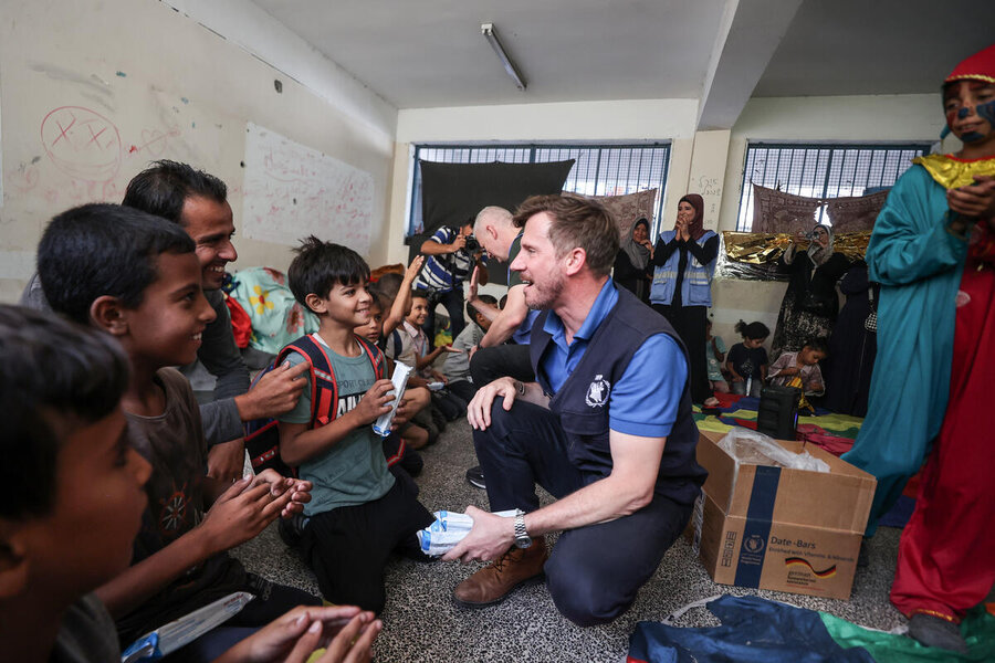 WFP Palestine Country Director Antoine Renard with children in Gaza - enjoying a brief moment amid the hardship. Photo: WFP/Ali Jadallah