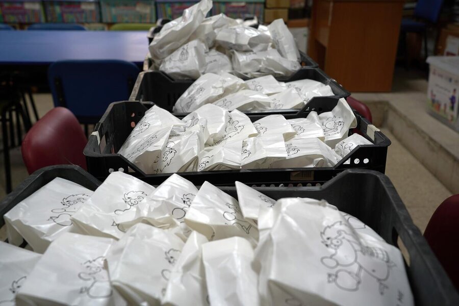 White packets containing school snacks in plastic trays