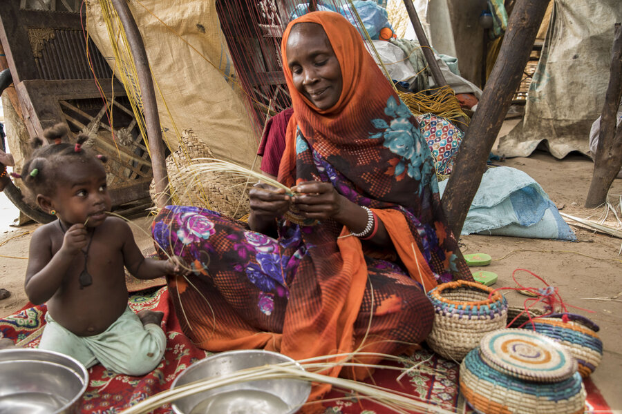 Sudanese refugee Kadija sells her handicraft to help feed her large family, thanks to basket-making skills she learned with WFP support. Photo: Aurore Vinot