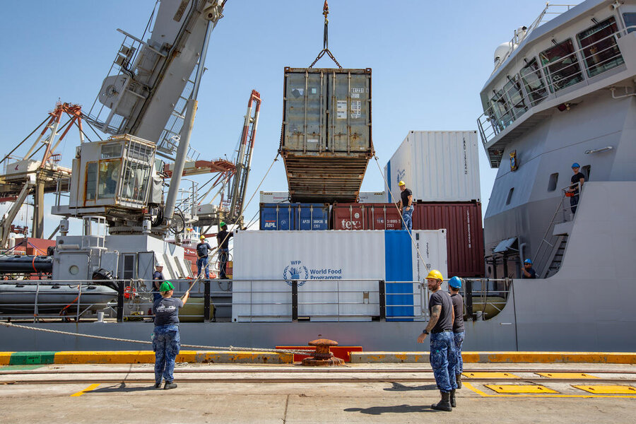 Workers oversee the loading to WFP cargo onto a ship. Photo: WFP/Irshad Khan