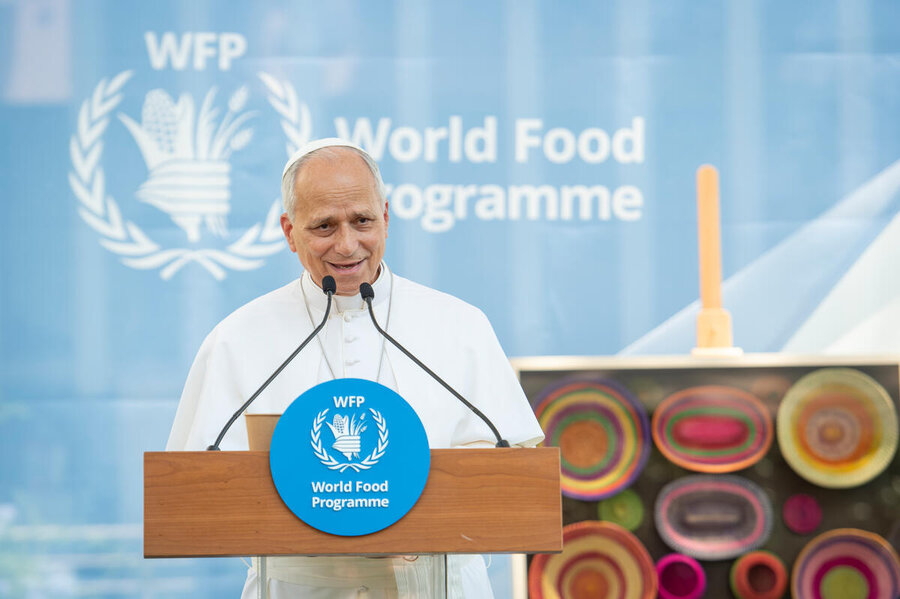 Speaker addresses audience at WFP Rome headquarters, standing at podium with World Food Programme logo and emblem backdrop