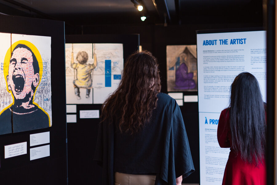 People at an exhibit reading information about it and looking at the art. Photo: WFP/Axel Brumberg