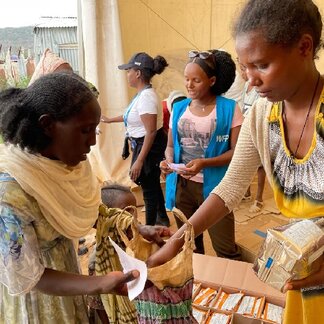 Woman receiving specialized nutritious foods. Photo: WFP/Claire Nevill