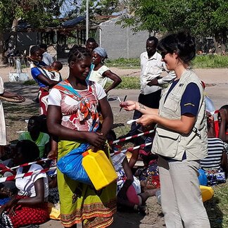 WFP staff conversing with a woman