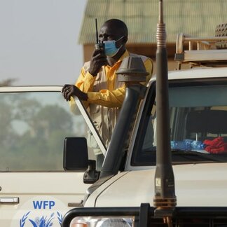 WFP staff talking with a wireless telephone in a car