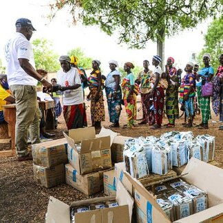 Men and women queuing to receive food and cash assistance in Savanes and Kara regions in Togo. Photo: WFP/Richard Mbouet