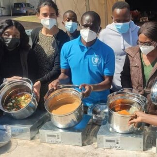 Group of people displaying cooked food