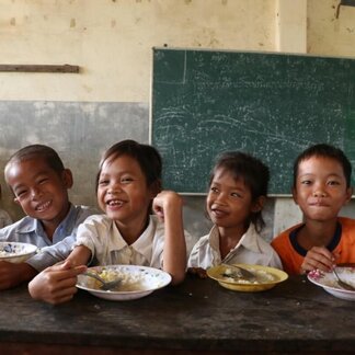 School kids eating nutritious meals in a classroom