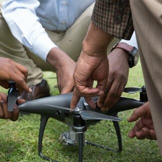 Men holding a drone